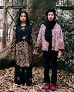 Two young ladies wearing batik outside - Darren Yaw Foo Hoe